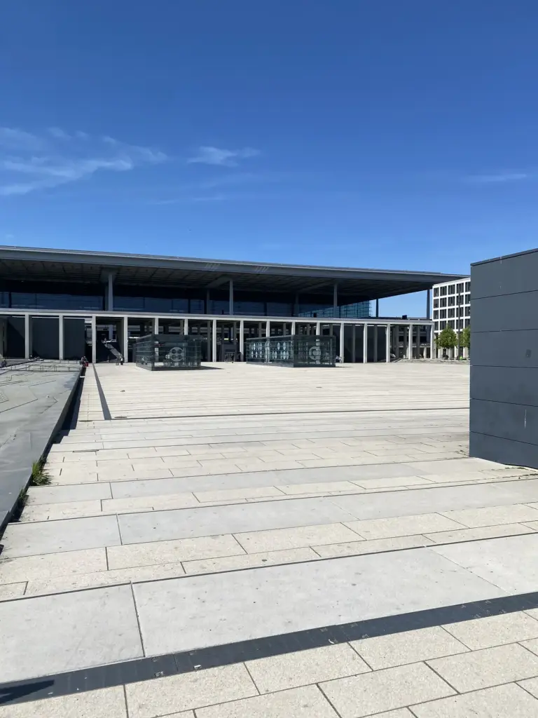 Willy Brandt Platz vor Terminal 1 des Flughafens BER mit den Glaskuben der Bahnhofszugänge